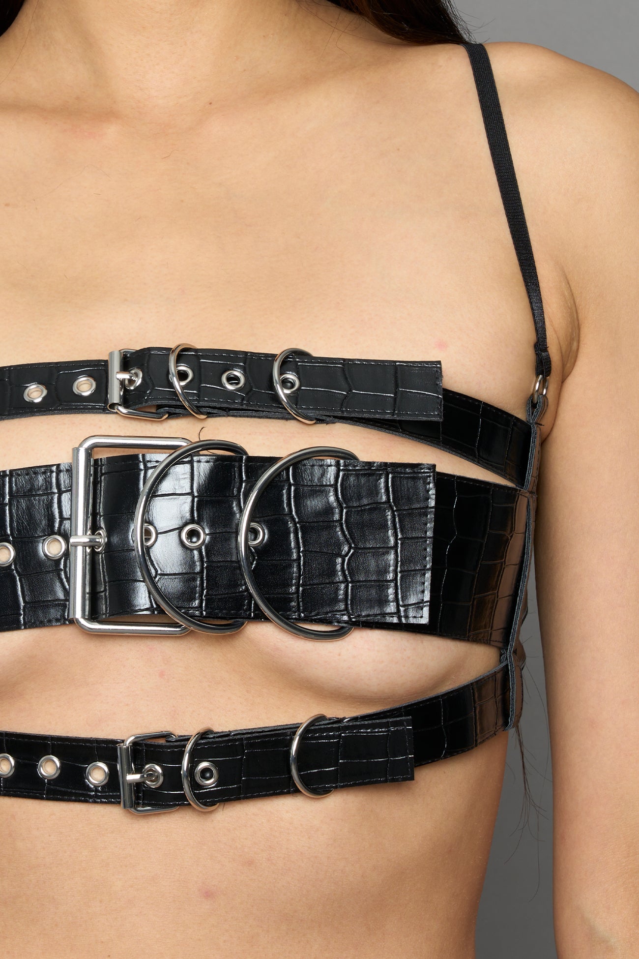Three adjustable belts with large metal buckles